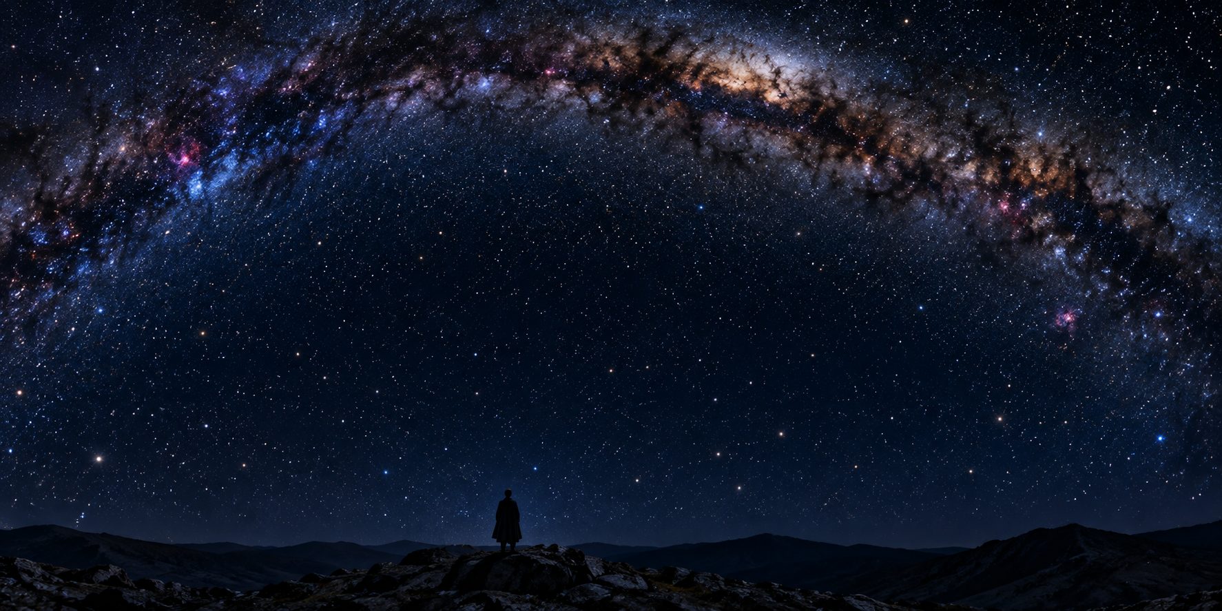 A vast night sky dense with stars over dark hills, a single small figure standing beneath it